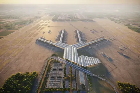 Nowoczesny terminal lotniczy, przypominający kształtem literę Y, z wieloma samolotami przy rękawach. To wizja największego lotniska w Europie, otoczonego pasami startowymi i zielenią.