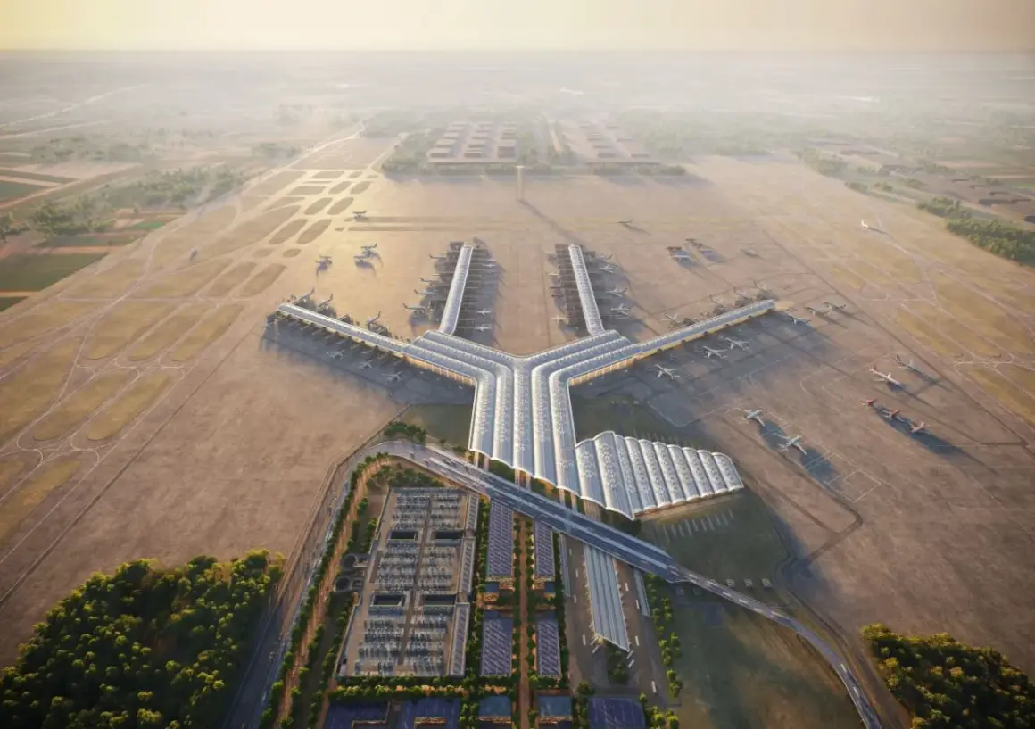 Nowoczesny terminal lotniczy, przypominający kształtem literę Y, z wieloma samolotami przy rękawach. To wizja największego lotniska w Europie, otoczonego pasami startowymi i zielenią.